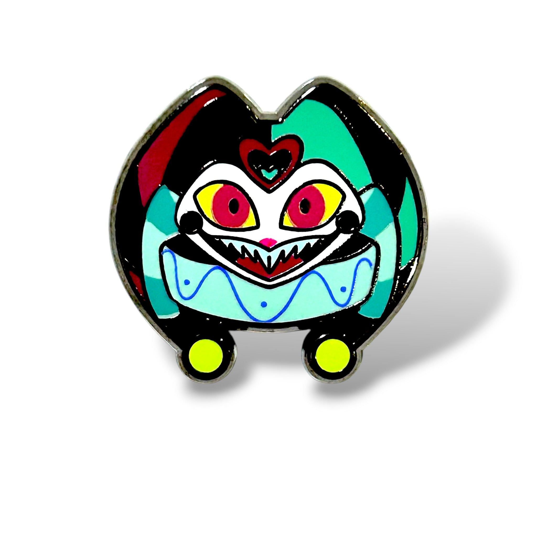 Cartoon-style enamel pin of a whimsical jester character with a rounded body and vibrant colors. The character has large yellow-and-red eyes with black pupils, a wide jagged mouth full of sharp teeth, and a small heart-shaped mark on its forehead. It wears a blue-and-white clown-style outfit with teal and black accents, plus two yellow circular feet. The design is outlined in metal with a glossy enamel finish, giving it a playful yet slightly eerie “Little Jester” aesthetic.