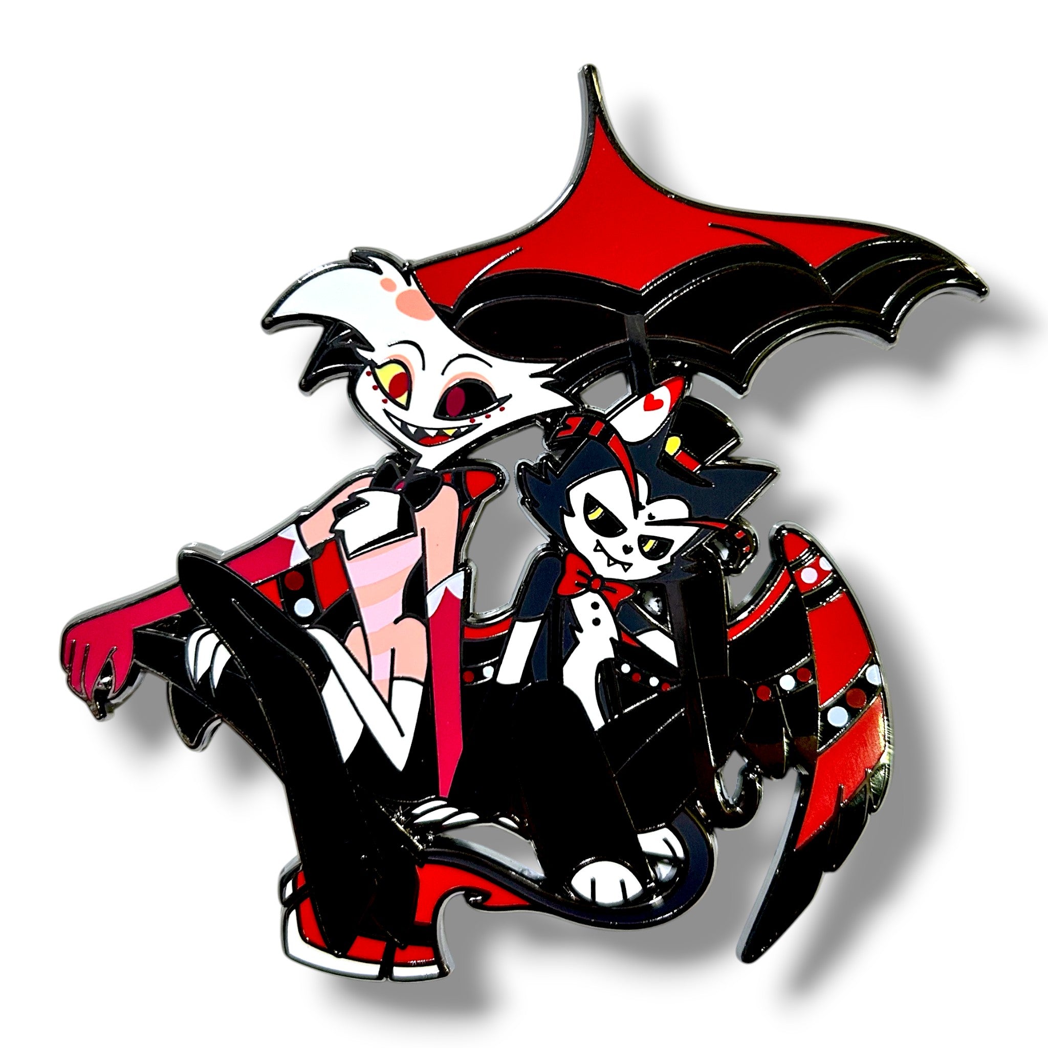 Stylized cartoon duo featuring one character with white skin, pink markings, red eyes, and a wide smile, and another with dark skin, white markings, red eyes, and a mischievous grin, both dressed in black and red outfits, with the second character holding a large black and red bat-themed umbrella, seated together in a bold, high-contrast enamel pin design