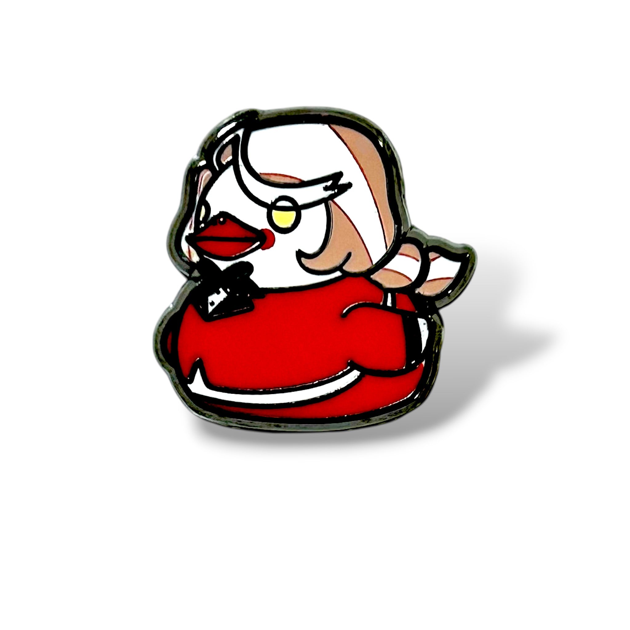 Cartoon-style enamel pin of a duck character dressed in a red outfit with white trim and a black bow tie. The duck has a white head with beige and pink streaks, yellow circular glasses, and red lips. The design features a glossy black outline and a whimsical, expressive look—capturing a bold, demon-princess aesthetic in a mini duck form.