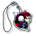 Cartoon-style acrylic keychain charm featuring two chibi siblings. One character is shown sleeping while being carried by the other, who has a gentle expression and wears a checkered outfit. The design is colorful and expressive, with exaggerated features typical of chibi art. The charm is attached to a black strap with a silver clasp, making it a collectible accessory for anime fans.
