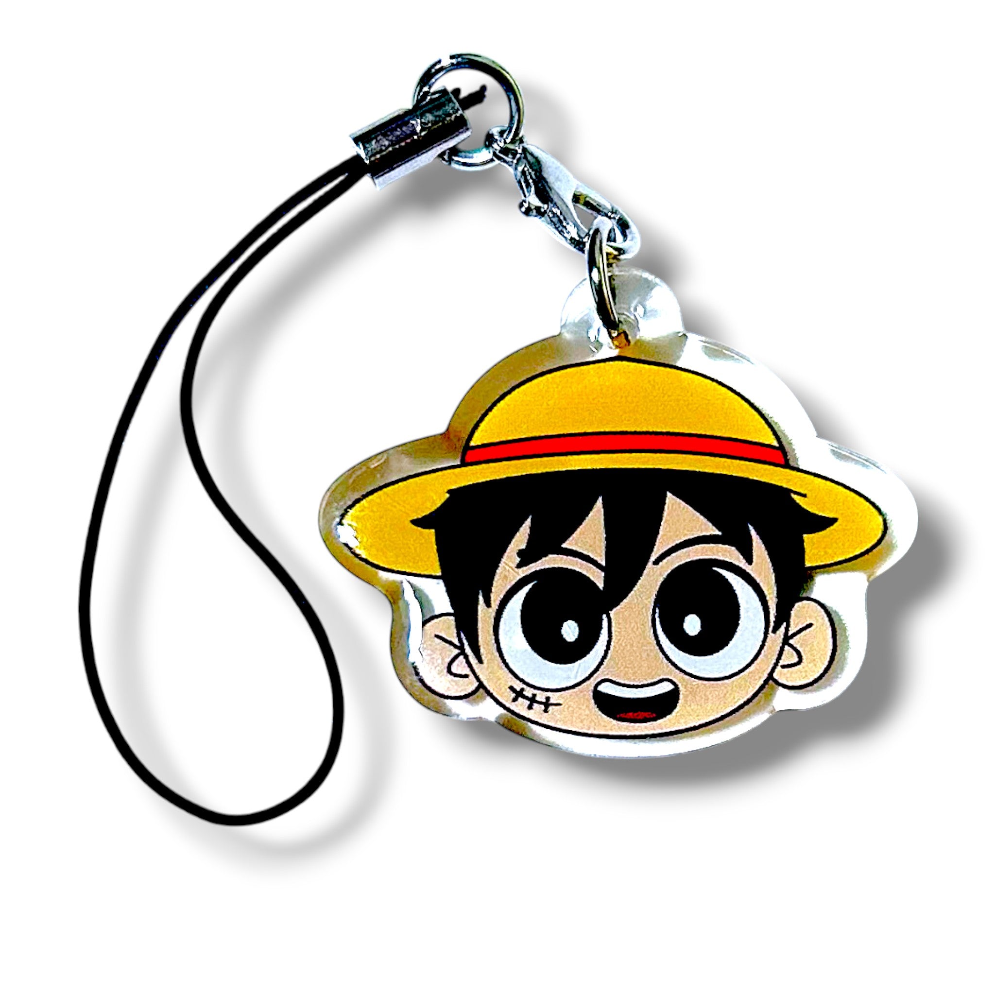 Cartoon-style keychain charm featuring a character head with a yellow straw hat and red band. The character has large, expressive eyes, black hair, and a small scar under the left eye. The charm is made of acrylic and attached to a black strap with a silver clasp. The design evokes a playful pirate theme with anime-inspired features, making it a collectible accessory for fans of adventurous characters.