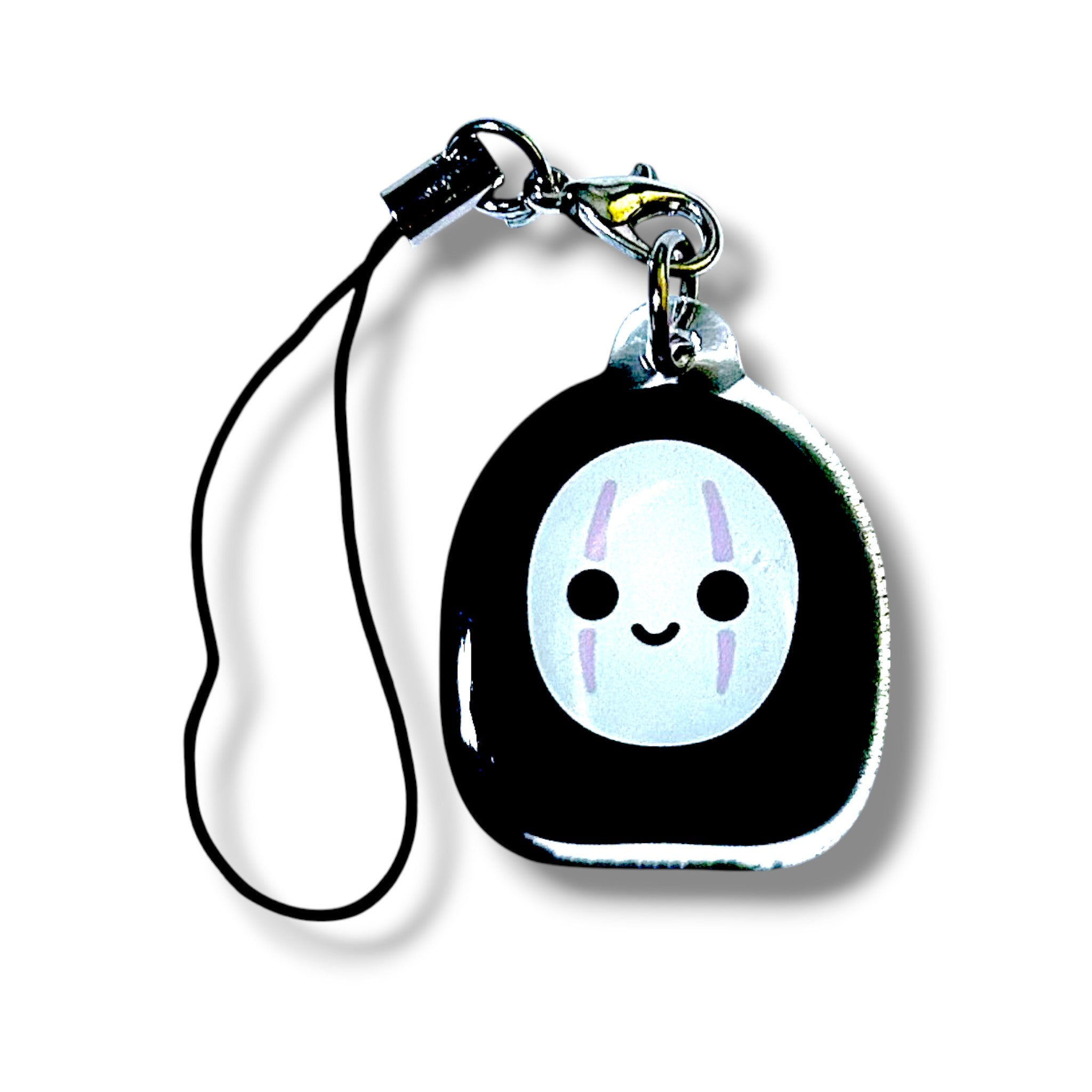 Cartoon-style keychain charm featuring a black bean-shaped body with a white oval face. The face has two vertical purple lines on each cheek, two black eyes, and a small smiling mouth, giving it a friendly and mysterious expression. The charm is made of acrylic and attached to a black strap with a silver clasp and ring. The design evokes a faceless spirit aesthetic inspired by anime, making it a whimsical and collectible accessory.