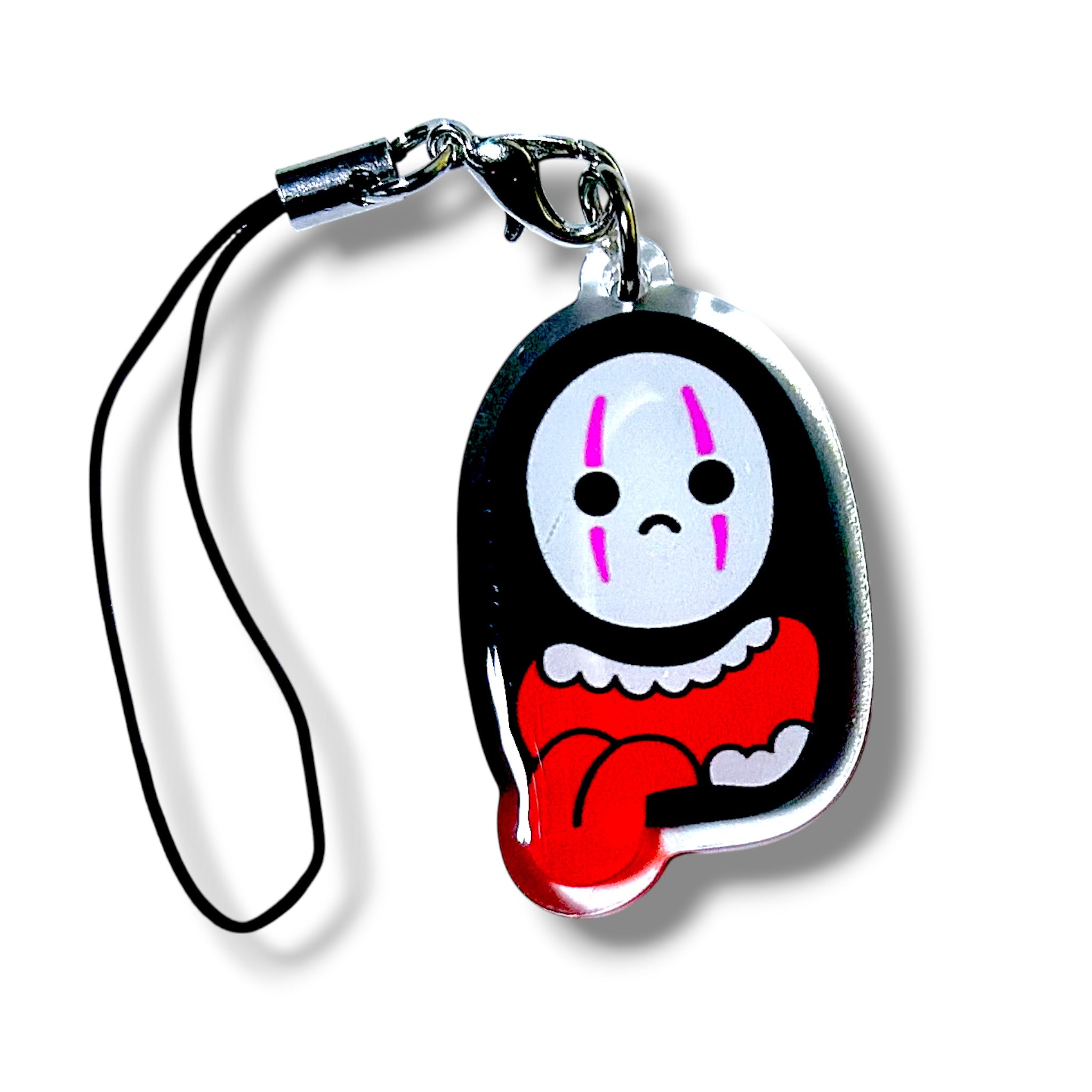 Stylized keychain charm featuring a faceless character with a white mask-like face, black eyes, and vertical pink markings above and below each eye. The character wears a black cloak with a red garment underneath and a white frilled collar. The charm is made of acrylic and attached to a black strap with a silver clasp. The design evokes a mysterious, anime-inspired aesthetic, making it a collectible accessory for fans of minimalist and symbolic characters.