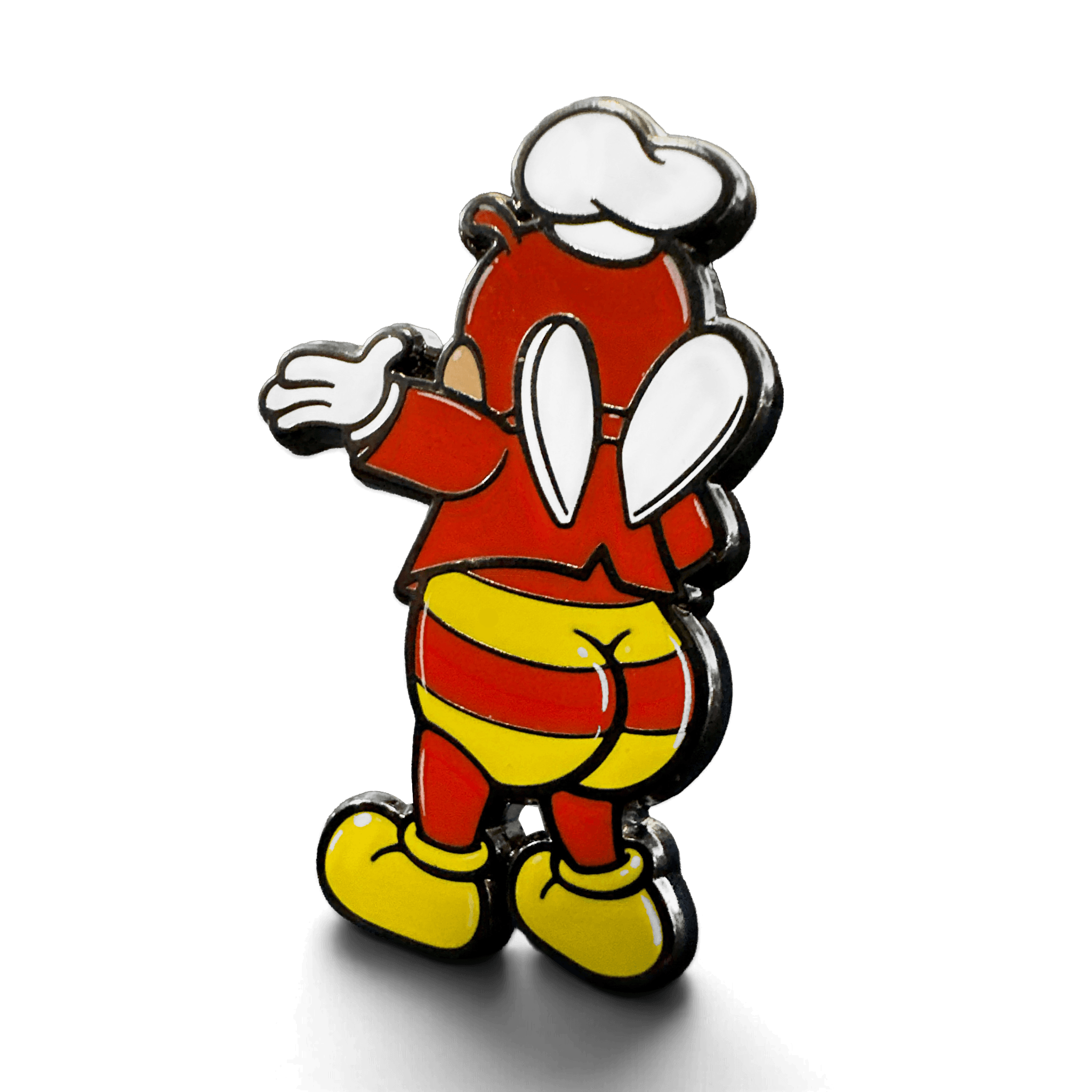 Angled view of the Jolli-Butt enamel pin featuring a red character with white gloves and goggles, yellow striped shorts, and yellow boots on a white background.