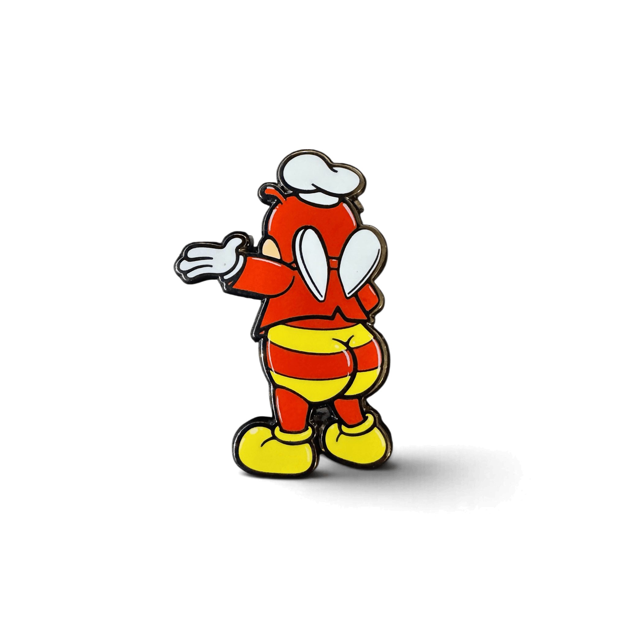 A cartoon-style Jolli-Butt enamel pin featuring a red character in a white chef’s hat, striped pants, and yellow shoes, shown from the back on a white background.
