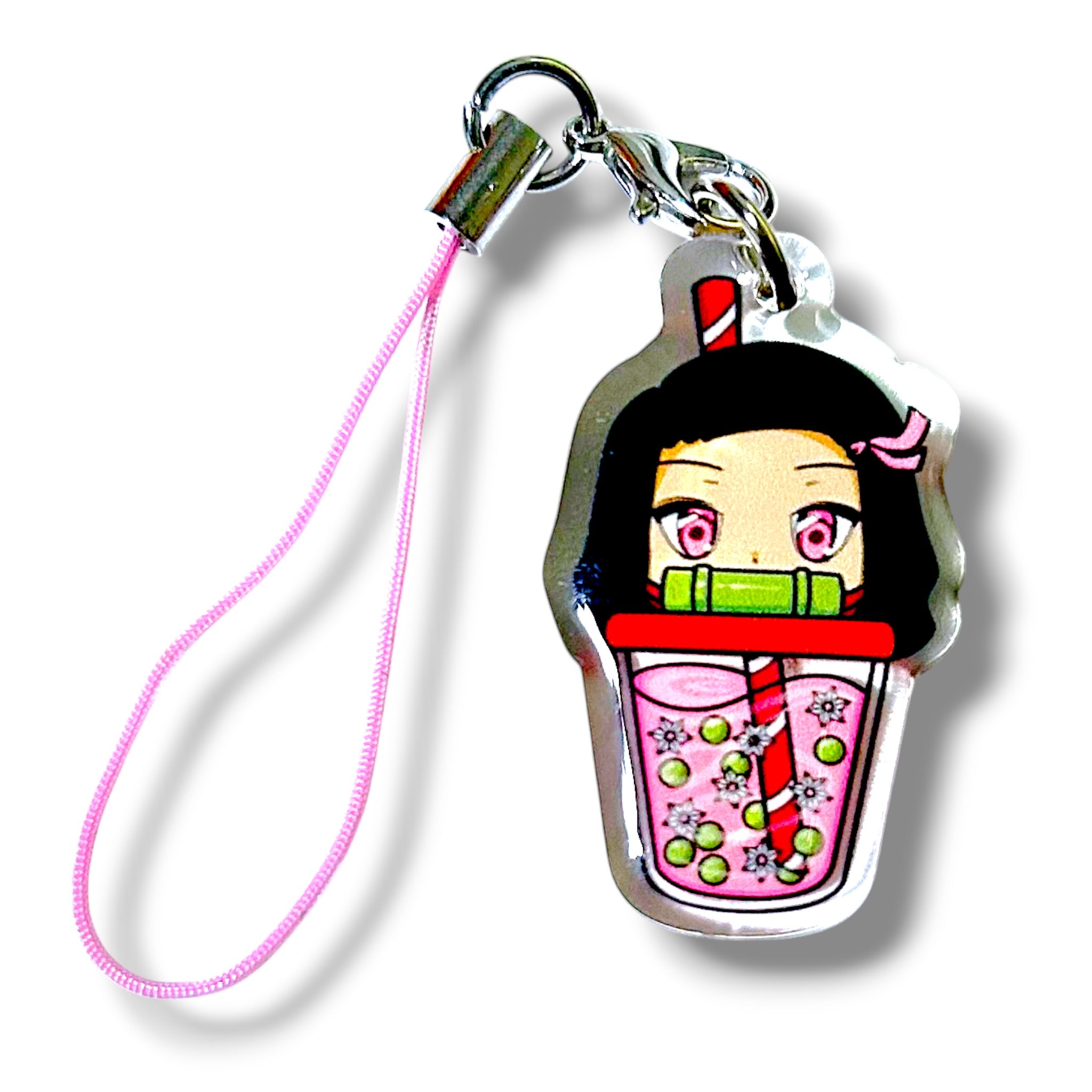 Cartoon-style keychain charm featuring an anime-inspired character inside a pink bubble teacup. The character has large eyes, black hair, and a pink hair clip, with their face visible through the cup. The cup contains green tapioca pearls and is topped with a red and white striped straw. The charm is made of clear acrylic and attached to a pink strap with a metal clasp. The design blends bubble tea aesthetics with a cute, sisterly anime vibe, making it a collectible accessory.