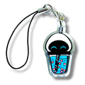 Cartoon-style keychain charm shaped like a bubble teacup with a domed lid and straw. The cup contains blue liquid and several pink tapioca pearls, designed in a playful, simplified style with bold outlines. The charm is made of clear acrylic and attached to a black strap with a metal clasp. The design blends sci-fi and kawaii aesthetics, resembling a space-themed robot accessory with a fun boba twist.