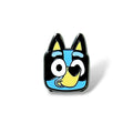 Cartoon-style enamel pin featuring a smiling blue dog character with black and yellow accents, large expressive eyes, and a cheerful expression; designed with bold lines and vibrant colors in a playful, simplified style.