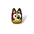 Cartoon-style enamel pin featuring a smiling orange and brown dog character with large white eyes and a black nose; designed with bold lines and vibrant colors in a playful, simplified style.