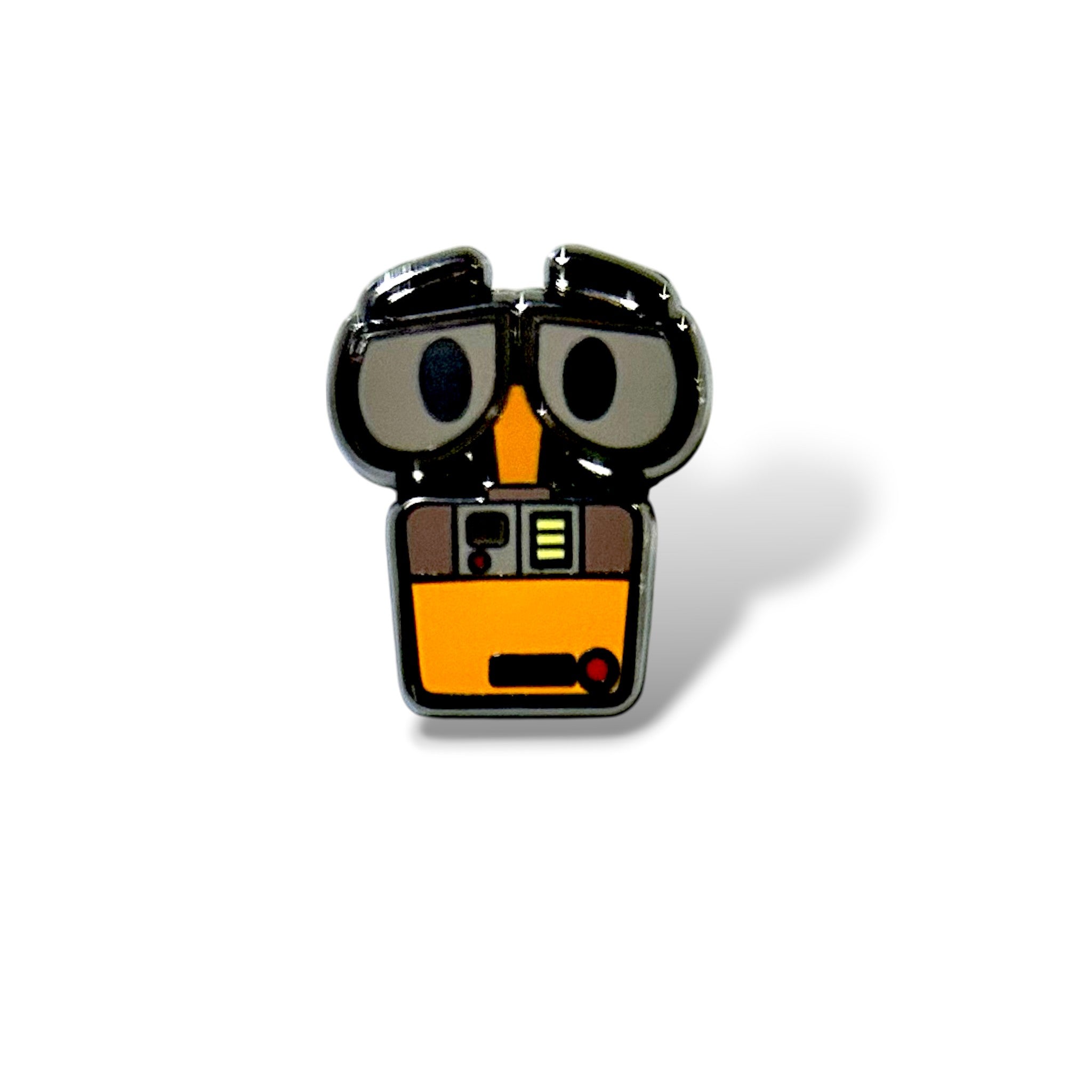 Enamel pin featuring a stylized yellow and orange robot with large expressive eyes, black detailing, and a compact upper-body design; inspired by futuristic character aesthetics and finished with a glossy hard enamel surface.