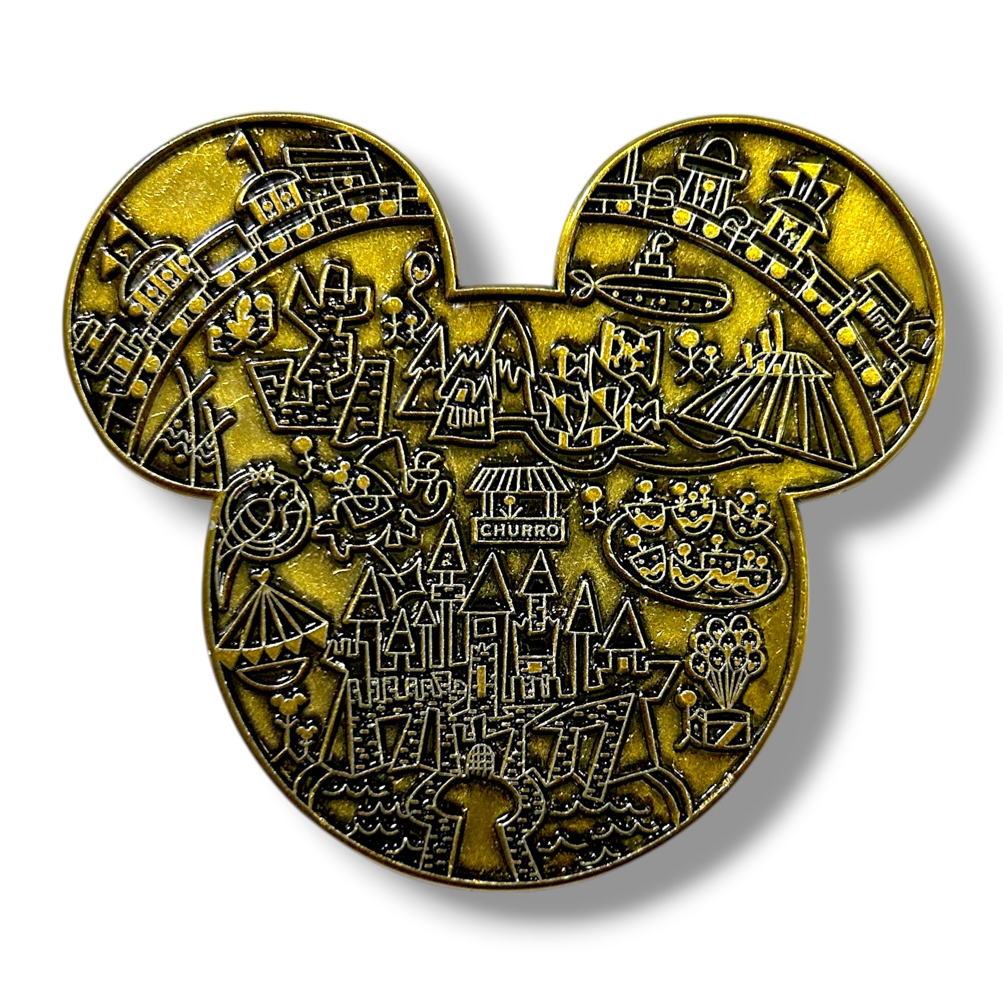 Gold enamel pin shaped like a mouse head silhouette, intricately engraved with detailed icons including a castle, pirate ship, mountain, rocket, haunted house, jungle cruise boat, monorail, teacup ride, Ferris wheel, and fireworks, creating a whimsical map-style design.