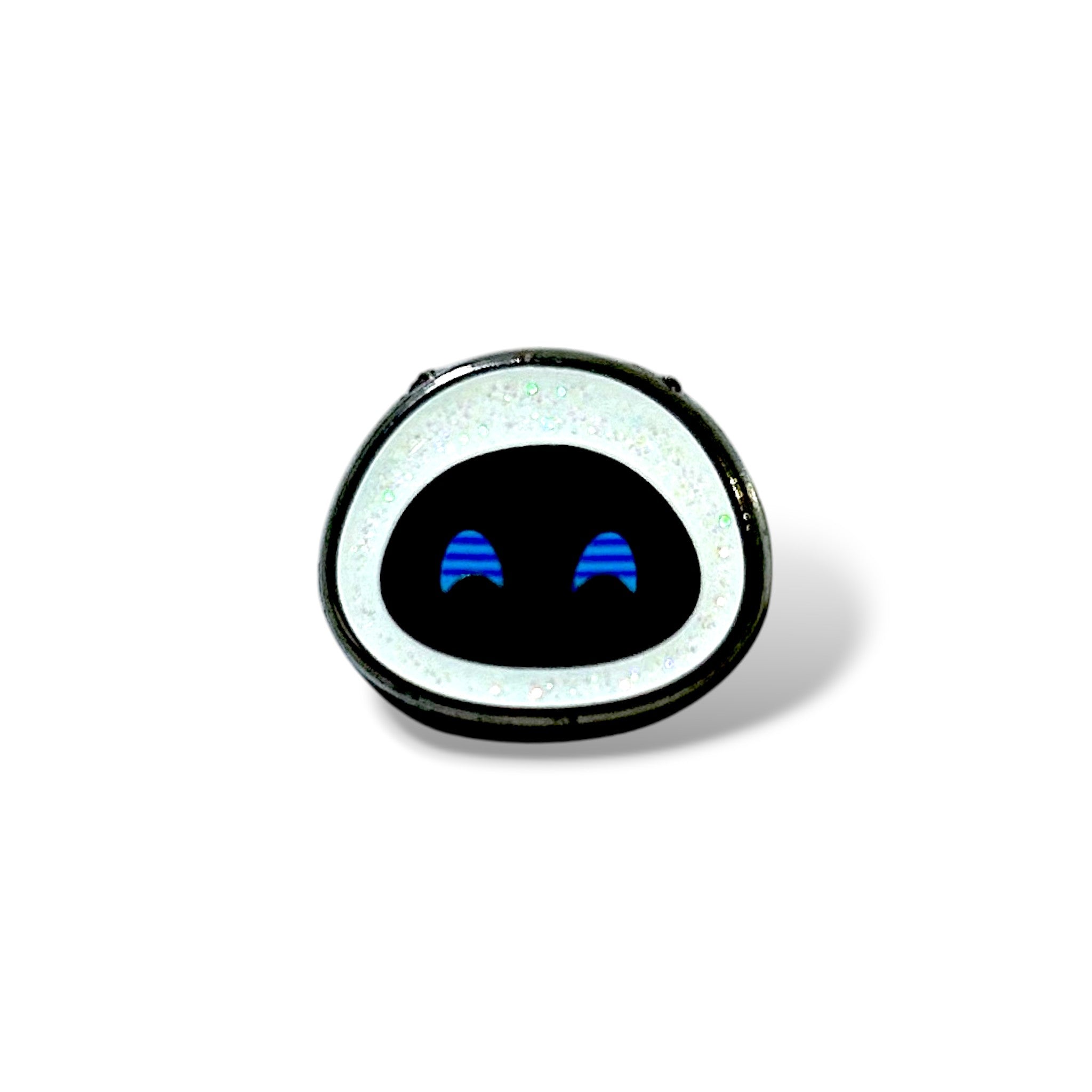 Stylized enamel pin featuring a minimalist robot face with a white glittery border and two blue crescent-shaped eyes on a glossy black background; inspired by futuristic character design.