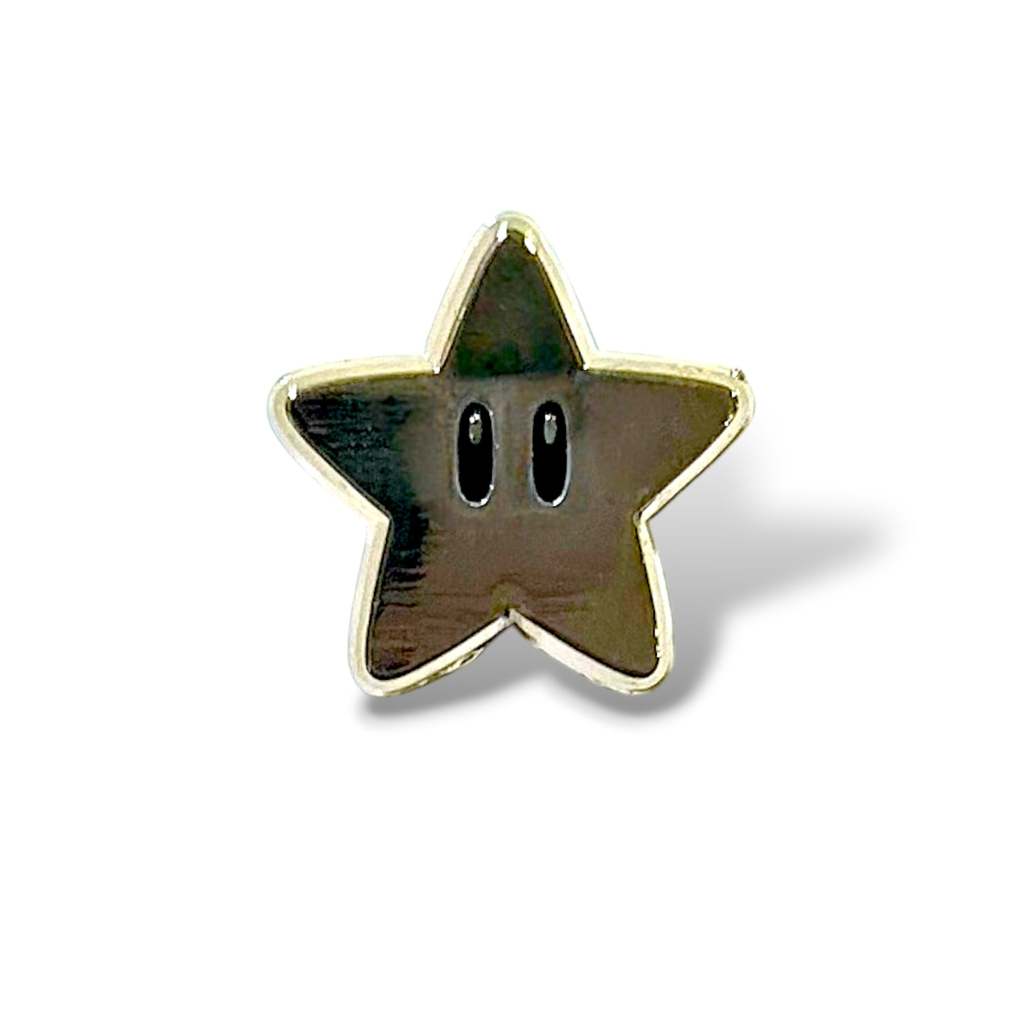 Enamel pin shaped like a five-pointed golden star with two black oval eyes in the center, glossy metallic finish, and playful design inspired by classic gaming power-ups.