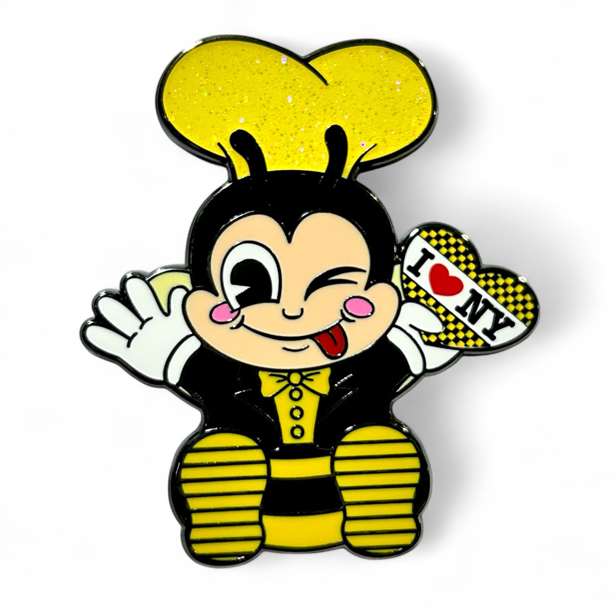 Playful cartoon bee character with a yellow heart-shaped headpiece, winking and sticking out its tongue, dressed in black and yellow, holding a heart-shaped 'I ♥ NY' sign with a checkered border.